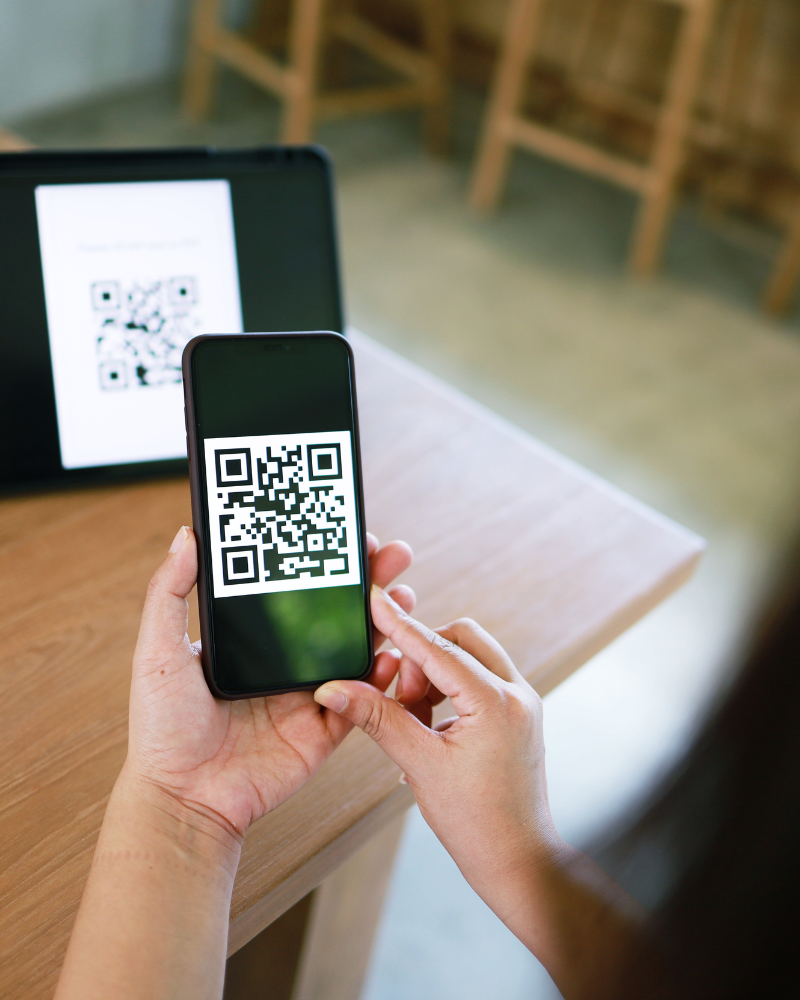 Person scannt QR-Code auf iPad ein